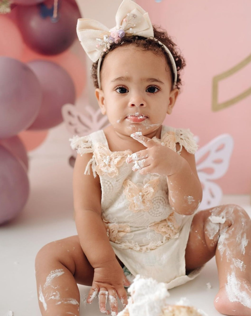 Children's beige bodysuit with butterfly