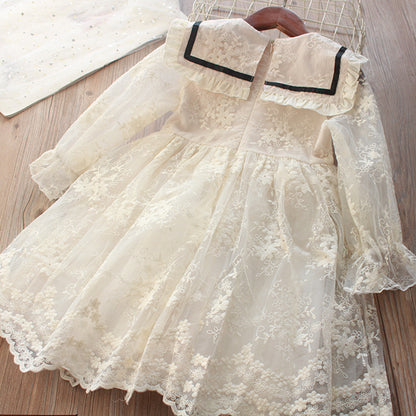 Delicate children's dress with lace and black bow