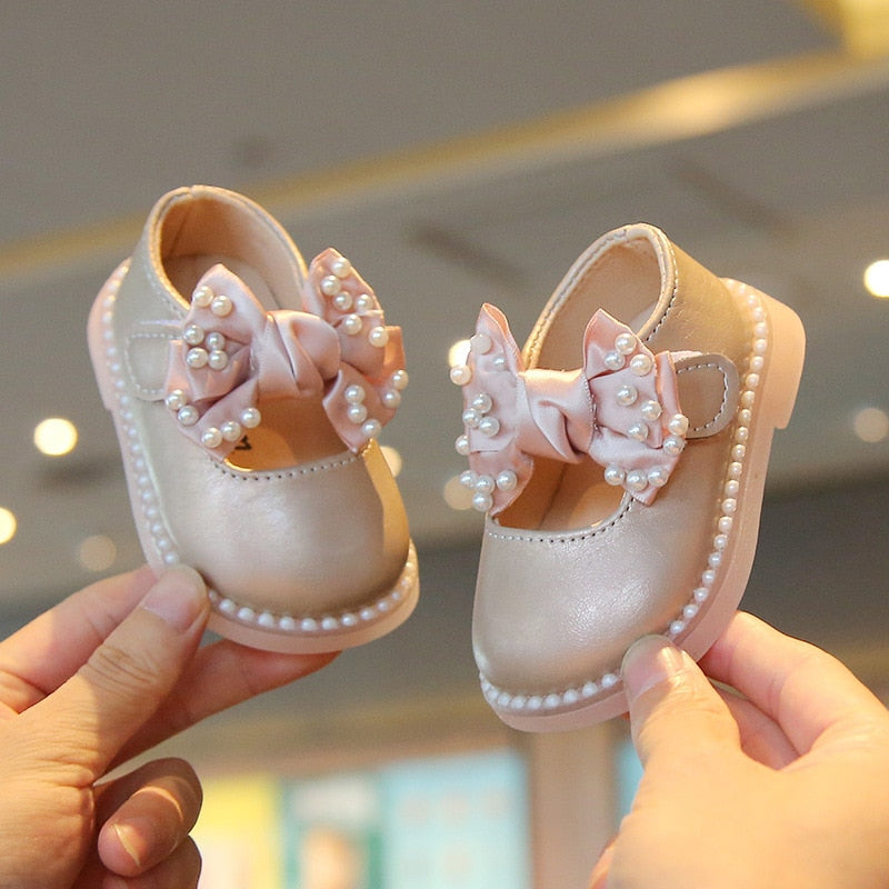 Children's shoe with bow and pearls