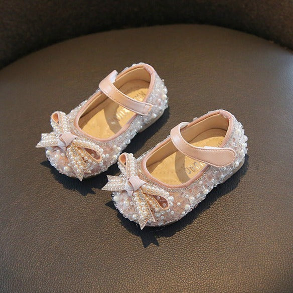 Children's shoe with glitter and bow