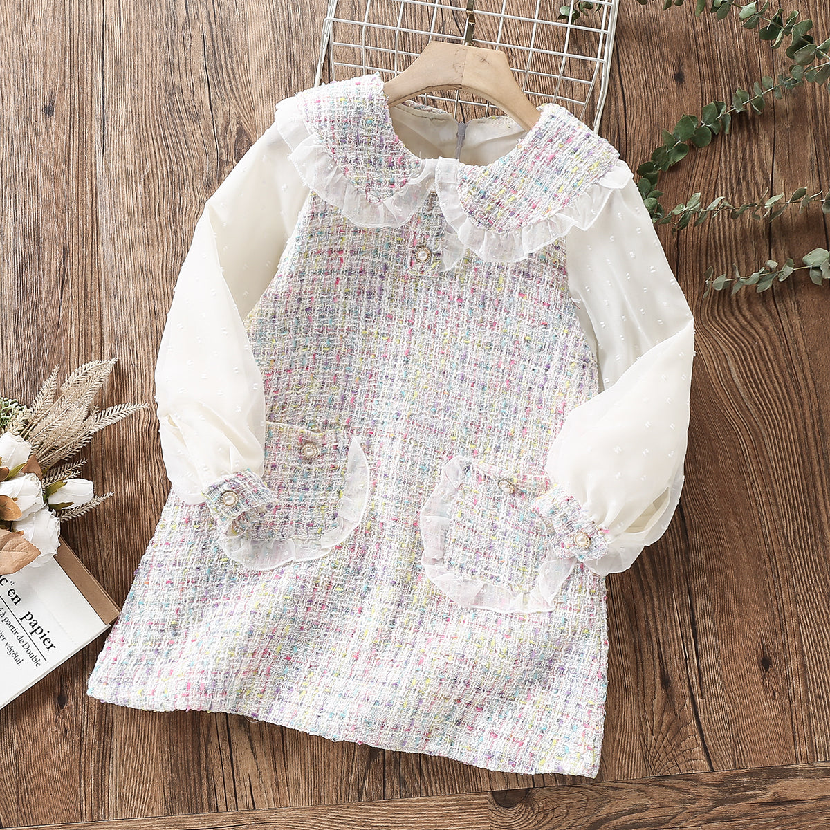 Delicate children's dress with lace and pearl buttons