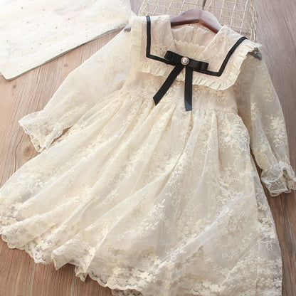 Delicate children's dress with lace and black bow